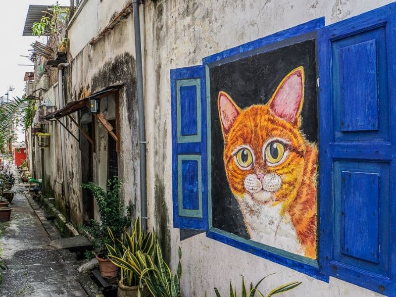 George Town heritage street in Penang with colourful shophouses and street art murals.