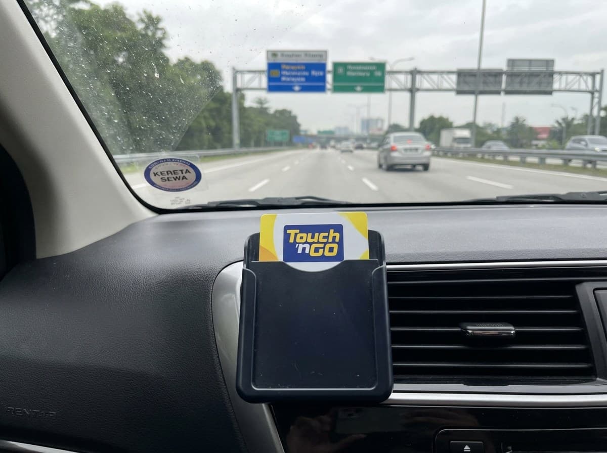 Touch n Go card holder on a rental car dashboard in Malaysia ready for highway tolls