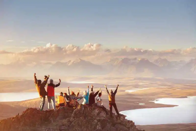 Group of People at the Mountain Top Overlooking the Valley